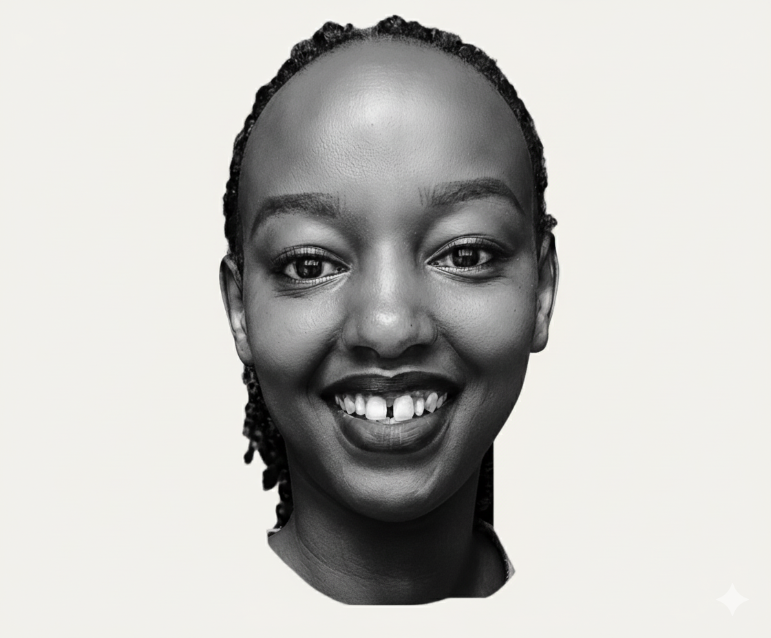 Christine Muhoro smiling confidently in professional attire, standing against a neutral background that conveys a sense of approachability and expertise